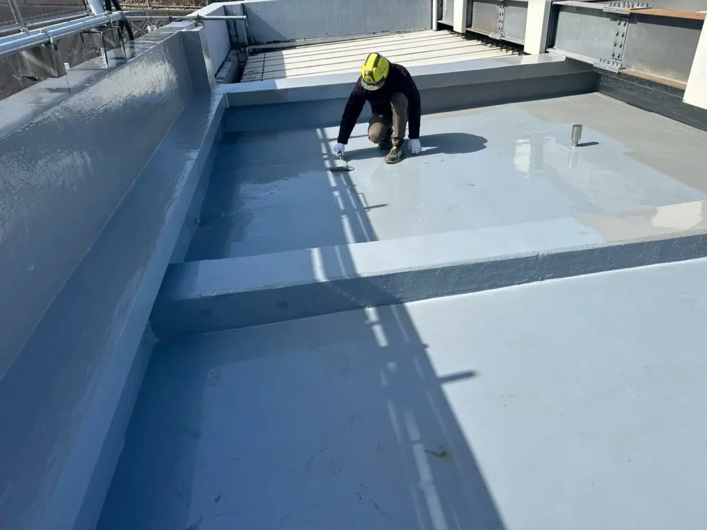 1層目のウレタン防水材を専用ローラーで均一に厚塗りする工程